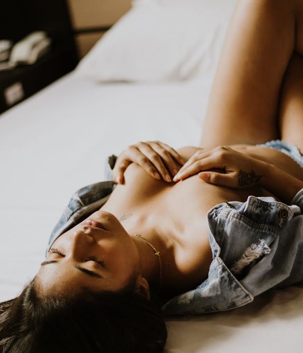 A serene woman in a calm, focused pose in a minimalist setting.